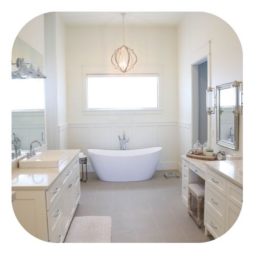 luxury bathroom with center tub and opposite vanities