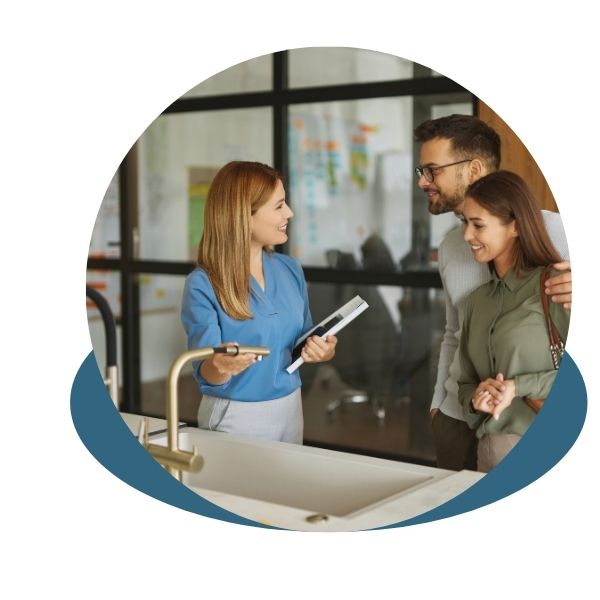 Salesperson showing sink options to a young couple