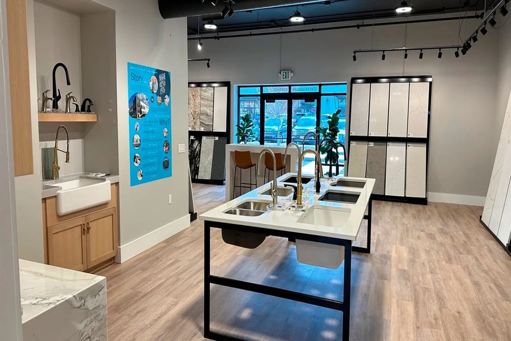 Homeowners comparing Carrara Pisa quartz at a Bedrock Quartz Utah showroom